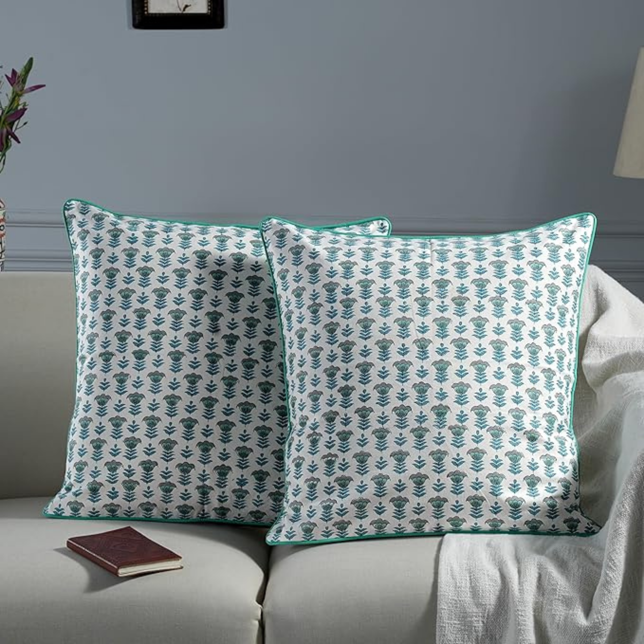 Pair of patterned pillows on a sofa with a neutral background