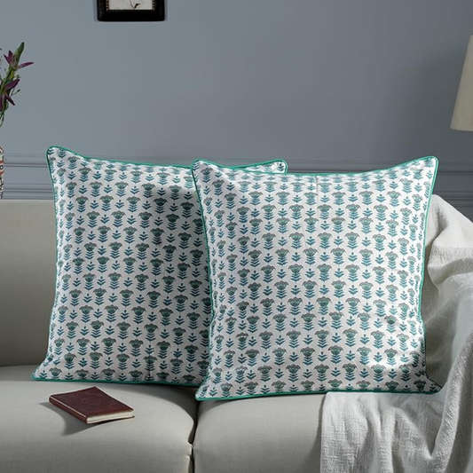 Pair of patterned pillows on a sofa with a neutral background