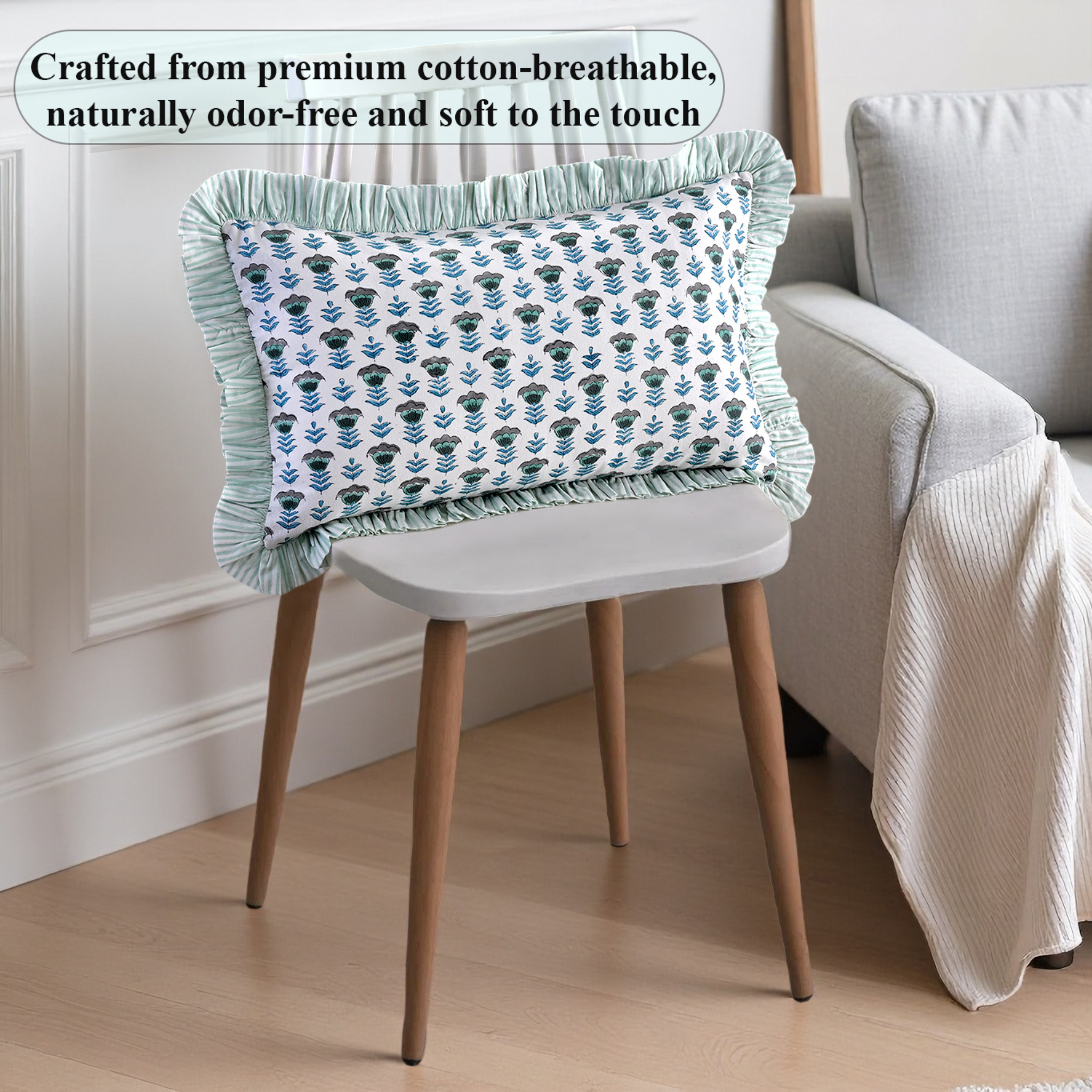 Decorative pillow with floral pattern on a chair in a room setting.