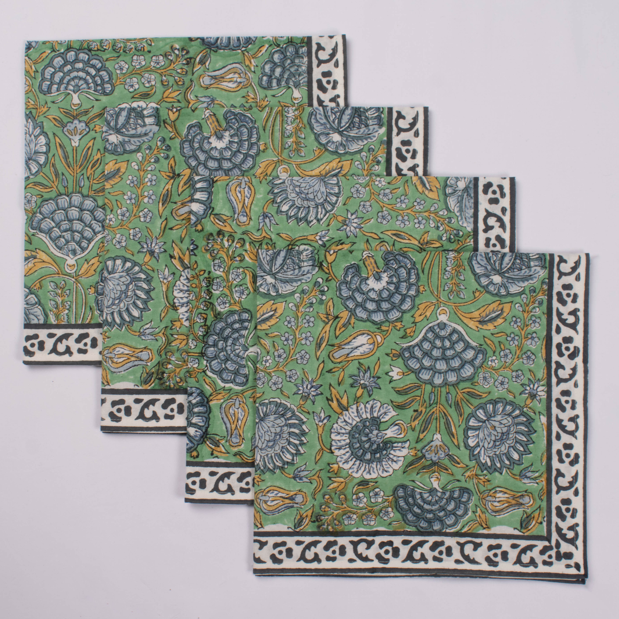Set of four floral patterned coasters on a light gray background