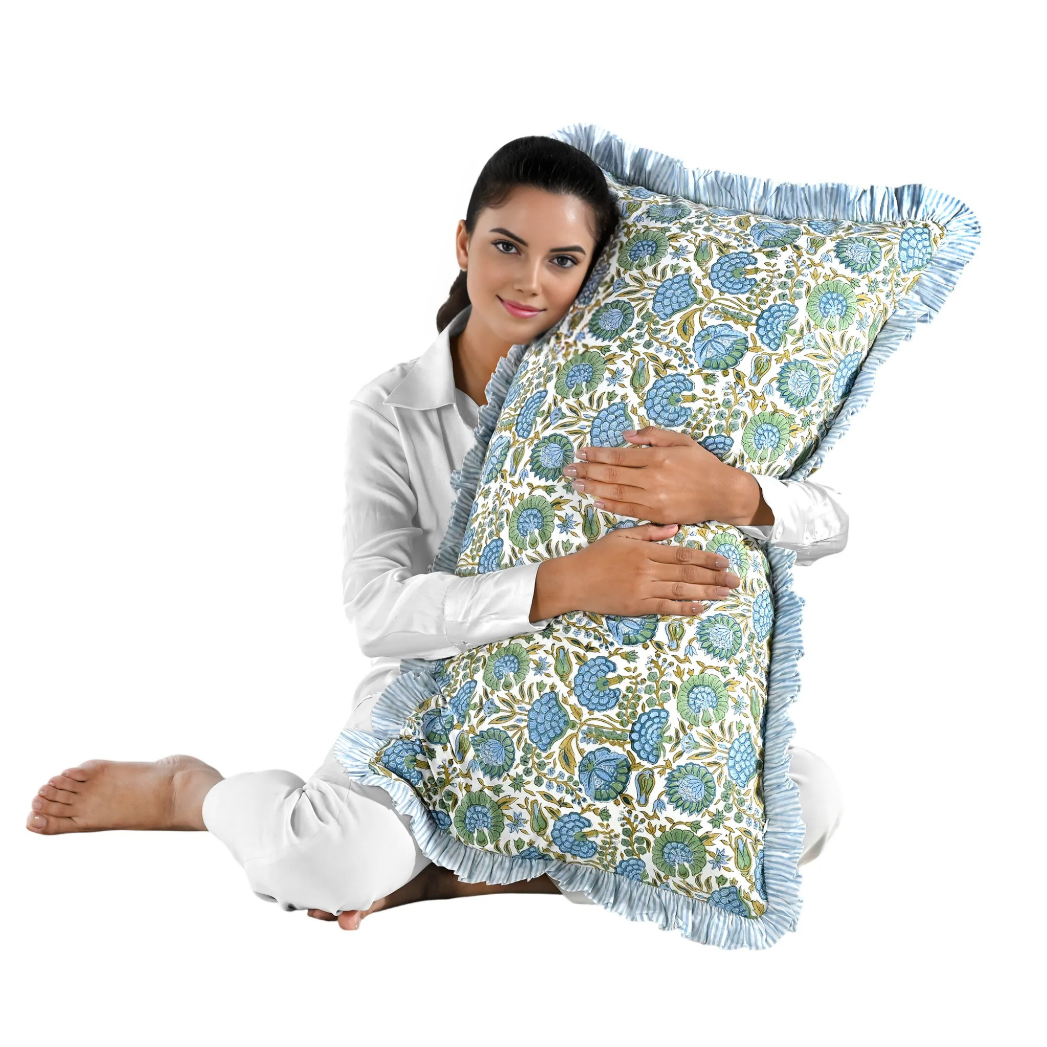 Woman holding a large blue floral block print cotton pillow with green edges.