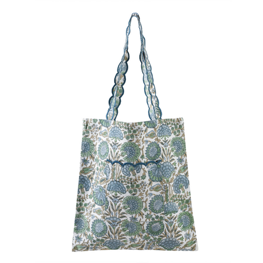Floral patterned tote bag with a decorative strap on a white background
