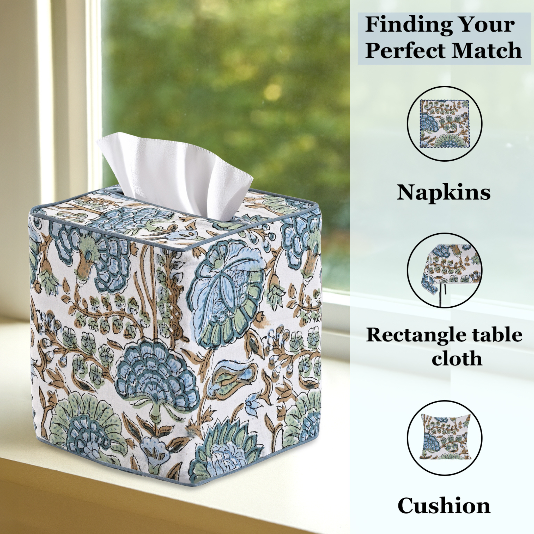 Tissue box cover with floral design on a surface with a window in the background.