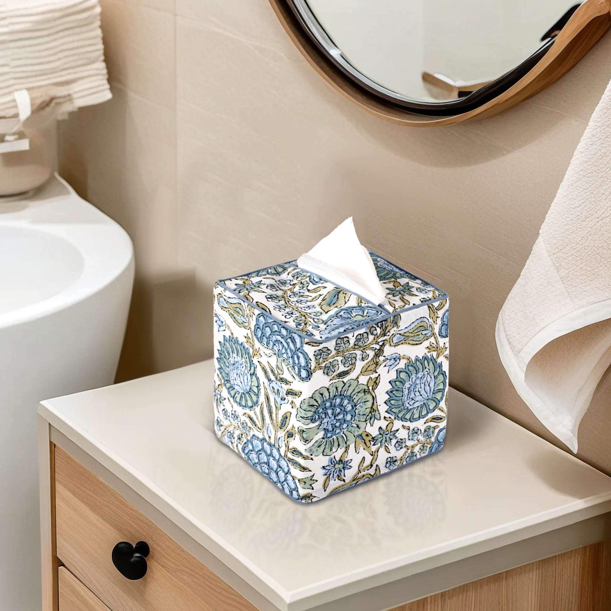 Floral-patterned tissue box on a bathroom counter with sink and mirror in the background