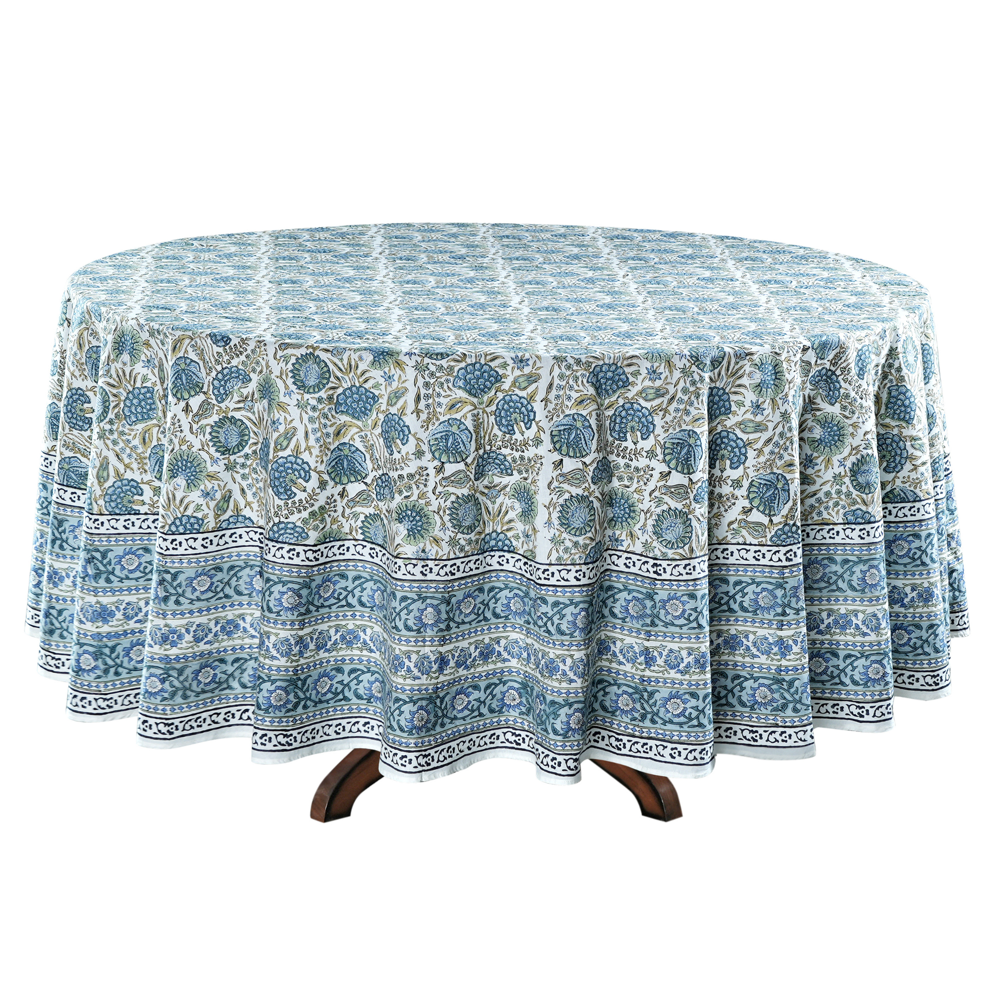 Round table with a blue and white patterned tablecloth on a white background