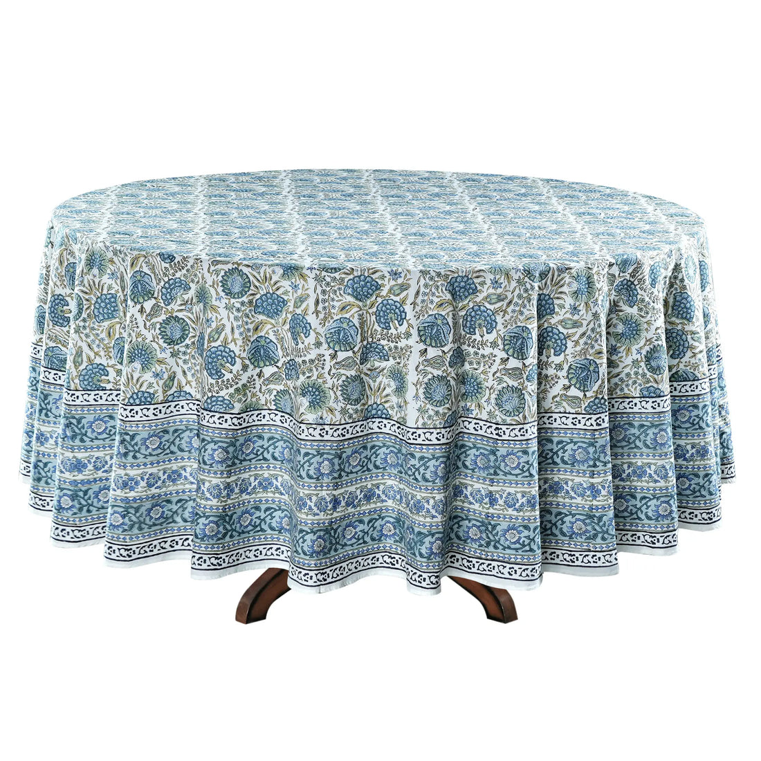 Round table with a blue and white patterned tablecloth on a white background