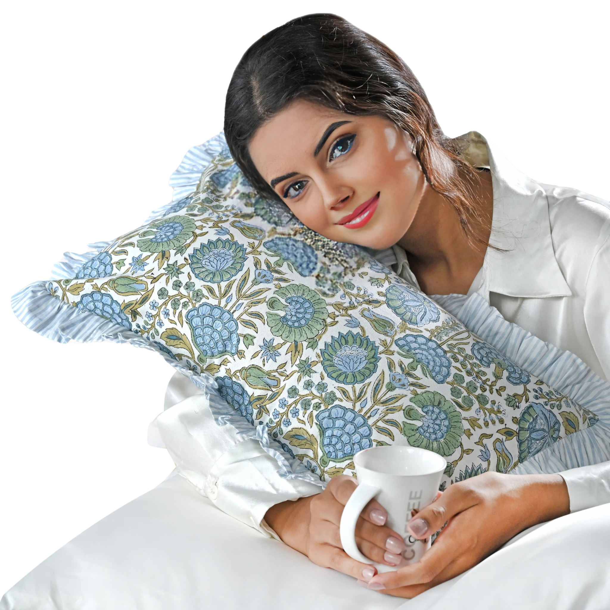 Woman holding a floral-patterned pillow and a mug on a white background