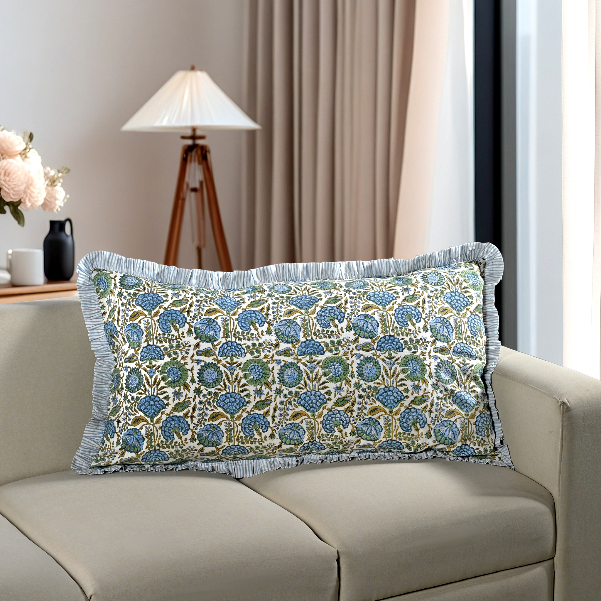 Blue floral block print cotton pillow styled on a beige sofa in living room.