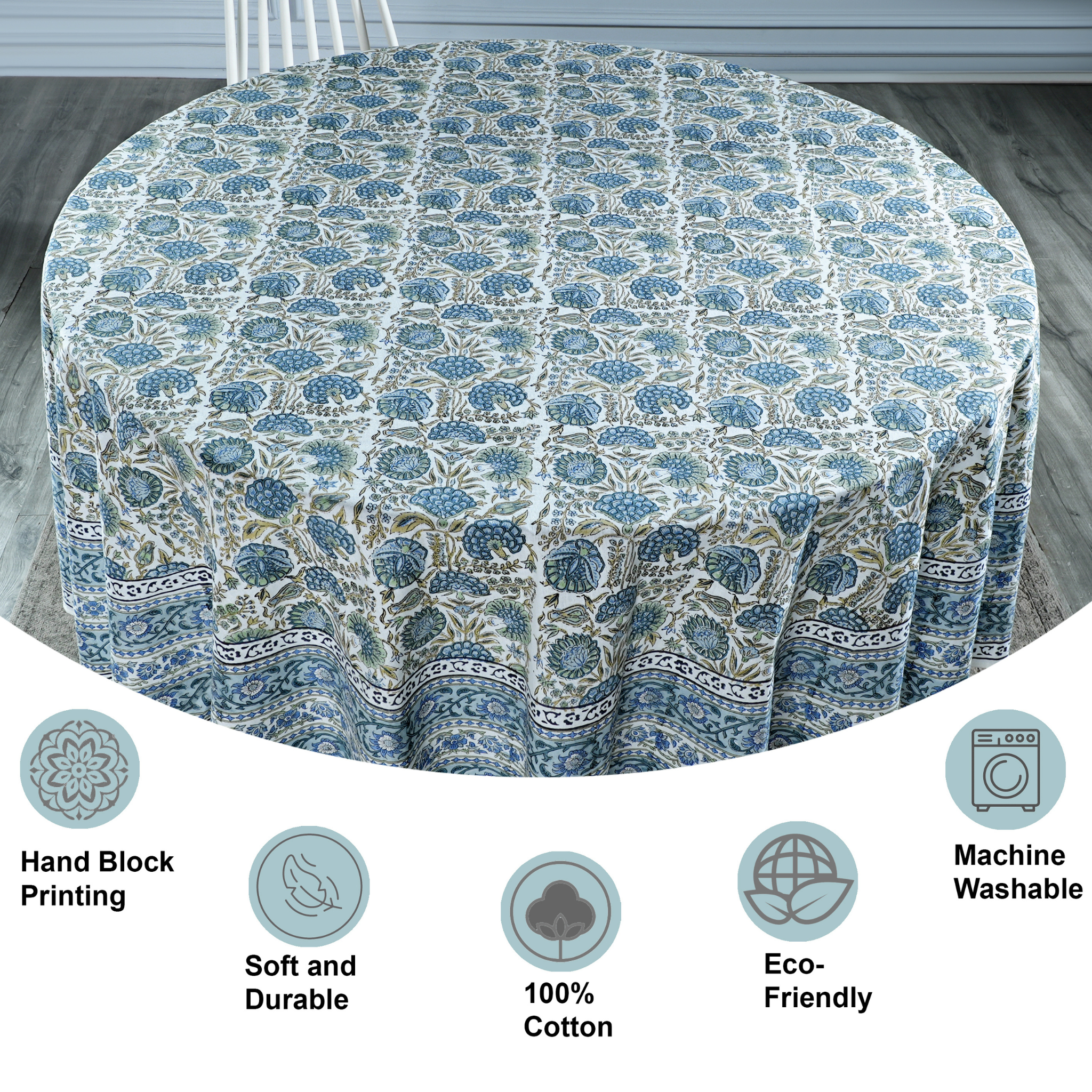 Round tablecloth with blue floral pattern on a wooden floor, featuring icons and text about material and care.