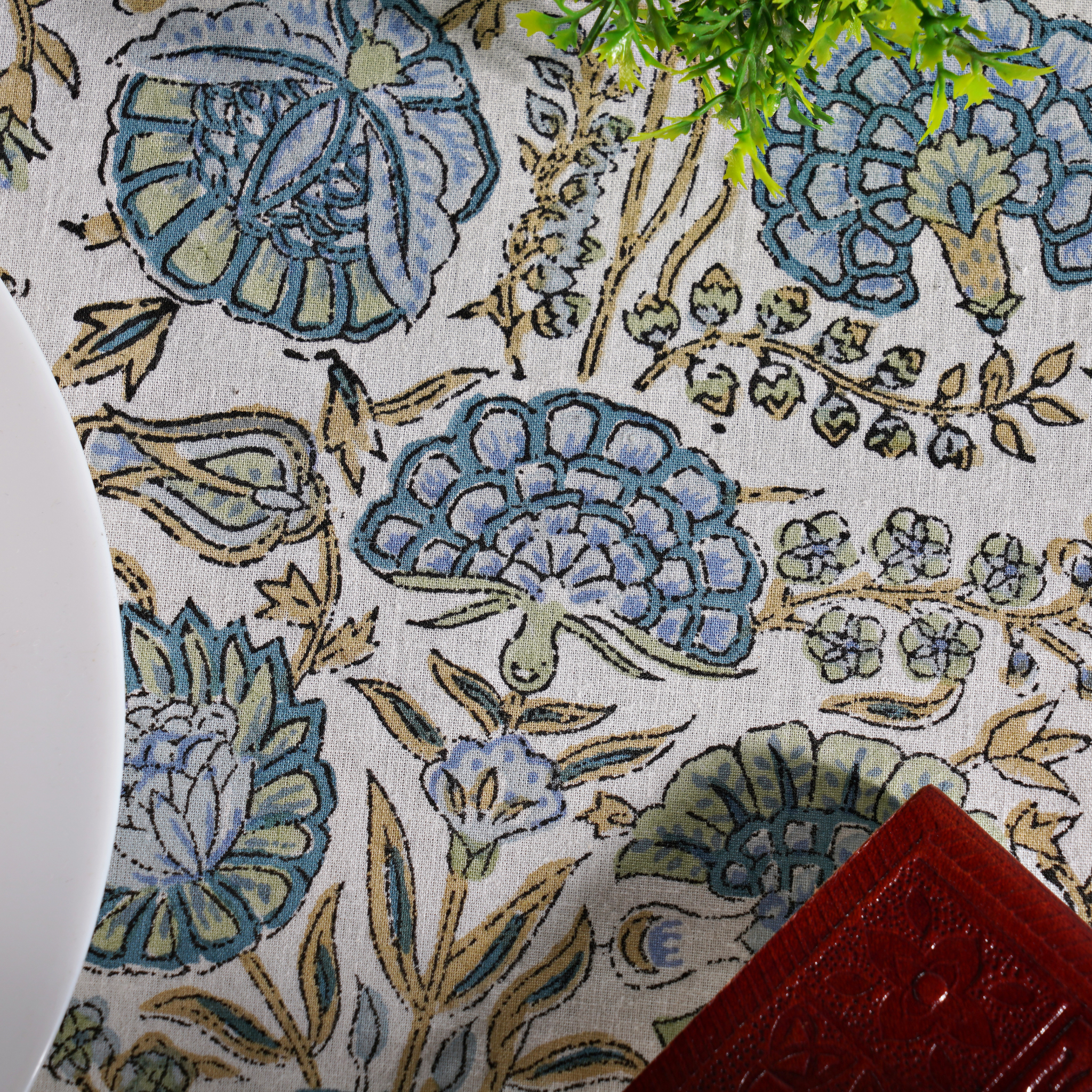 Close-up of a floral patterned fabric with blue and green colors.