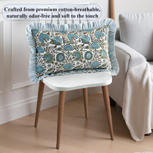 Decorative pillow with floral pattern on a chair in a room setting.