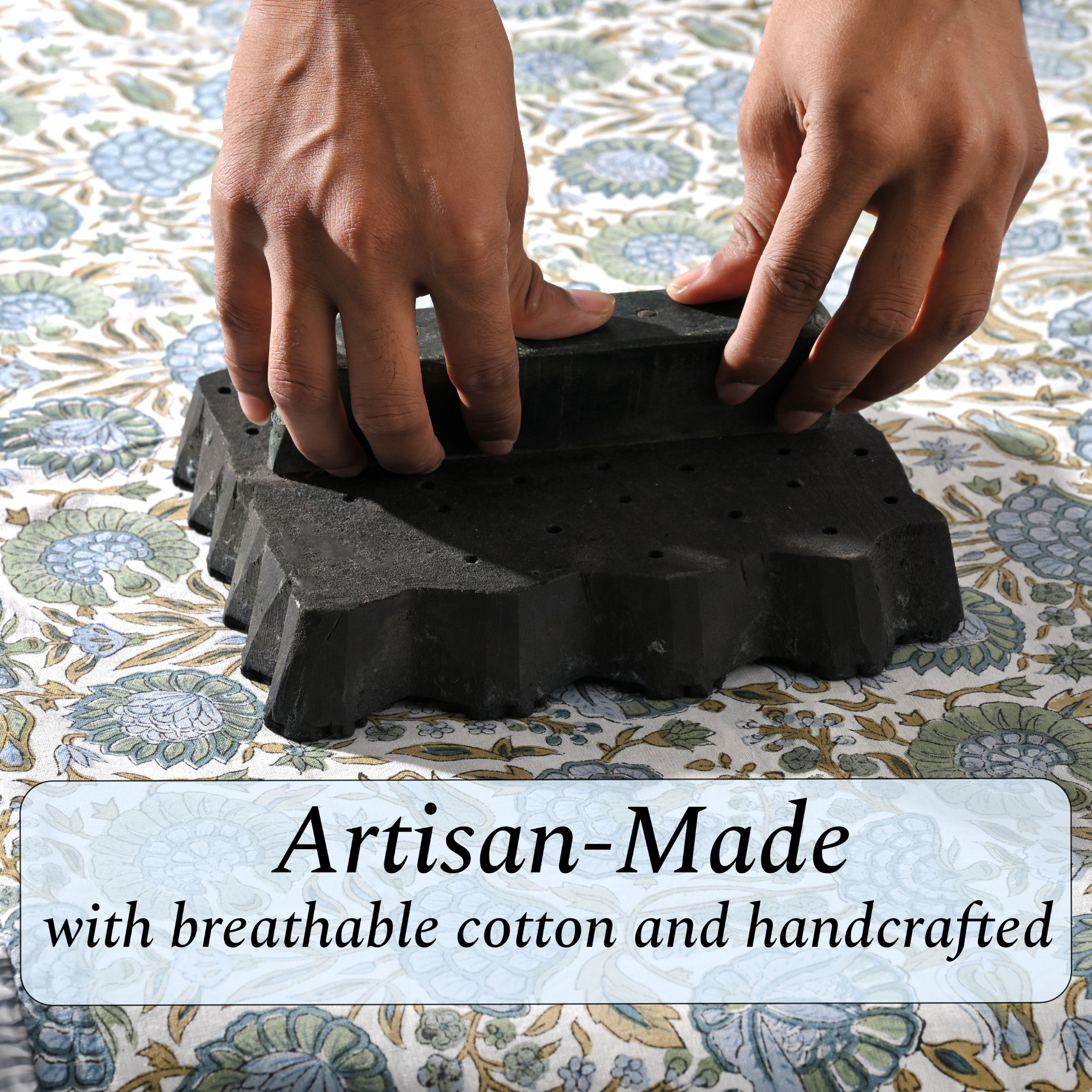 Artisan hand-block printing floral design on cotton fabric.