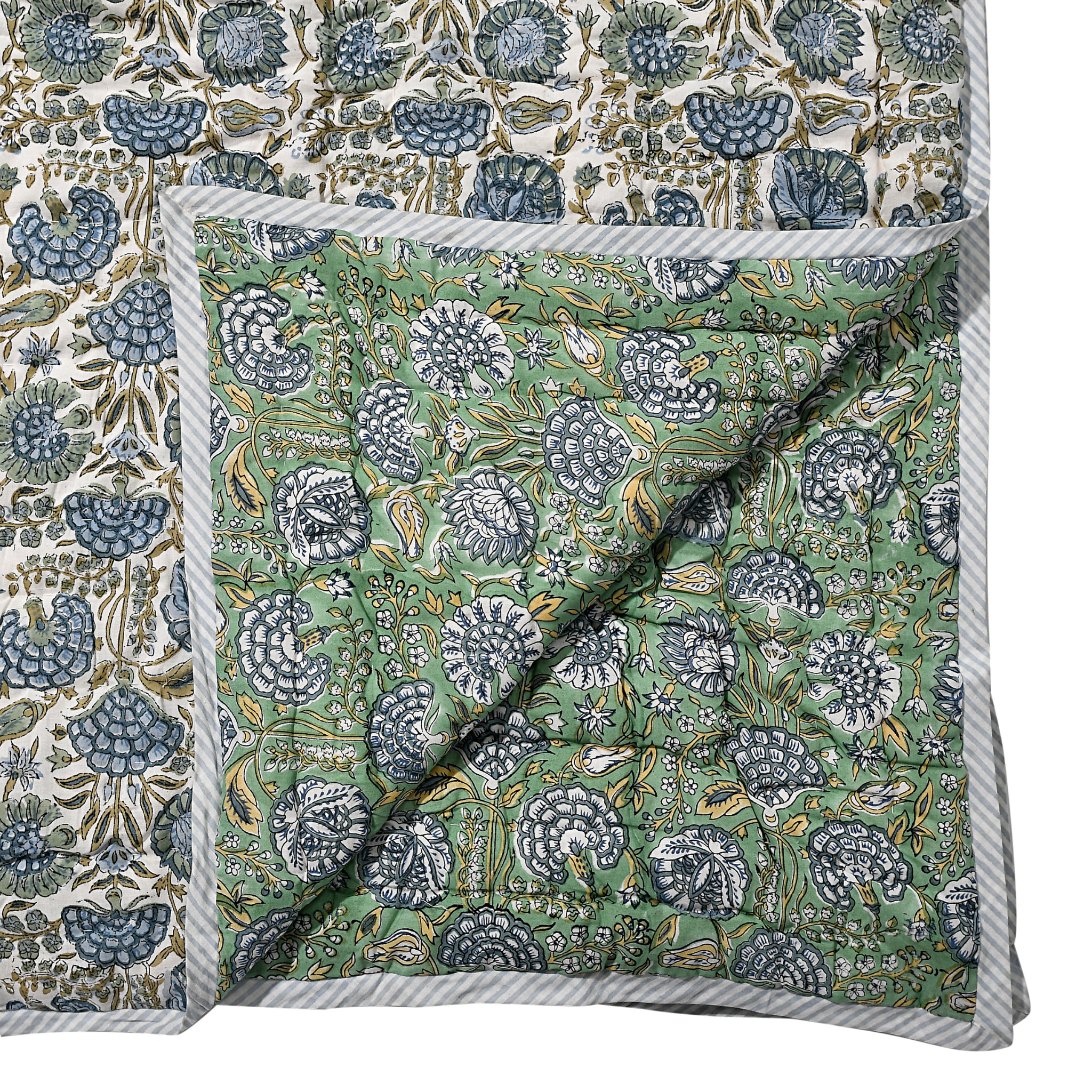 Floral patterned fabric with a green and blue design on a white background