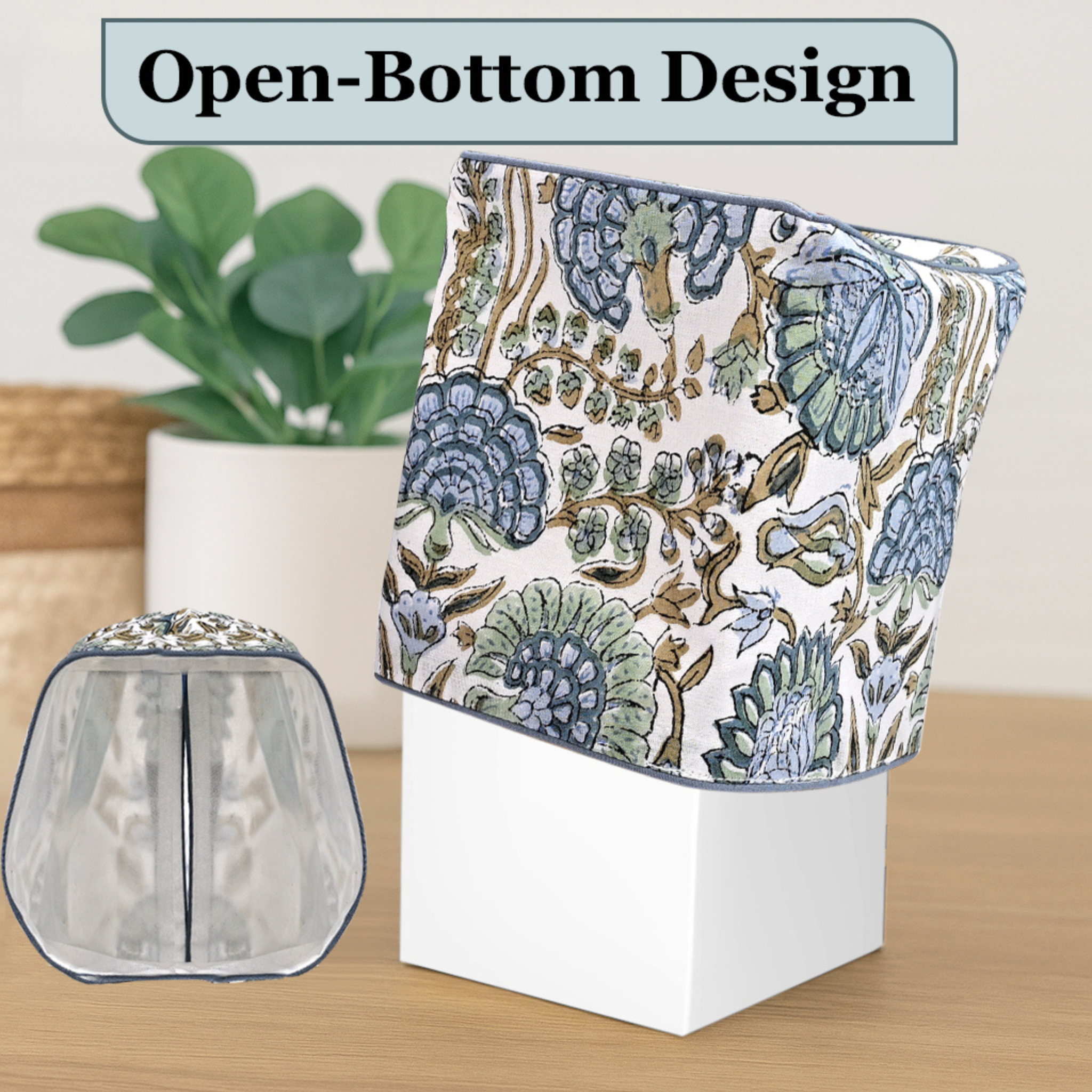 Floral-patterned product with open-bottom design on a wooden surface, plant in the background.