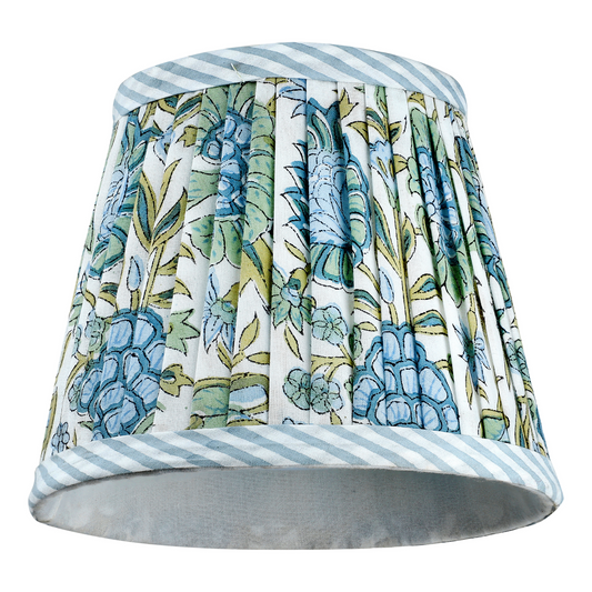 Decorative lampshade with floral pattern and striped edges on a white background