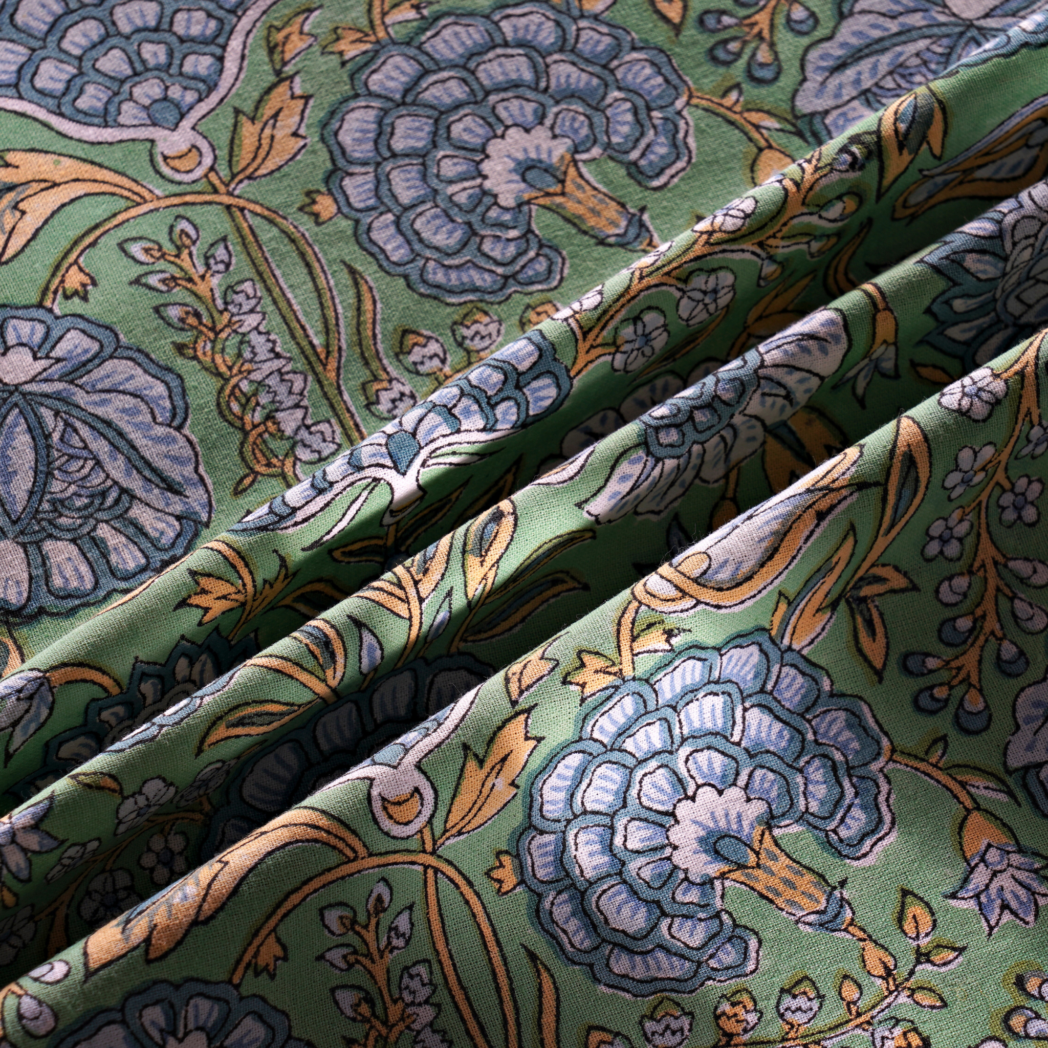 Close-up of floral patterned fabric with green background