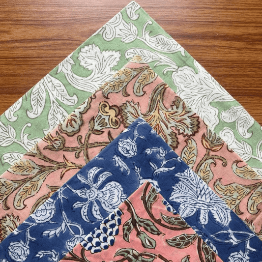 Three floral patterned napkins on a wooden surface