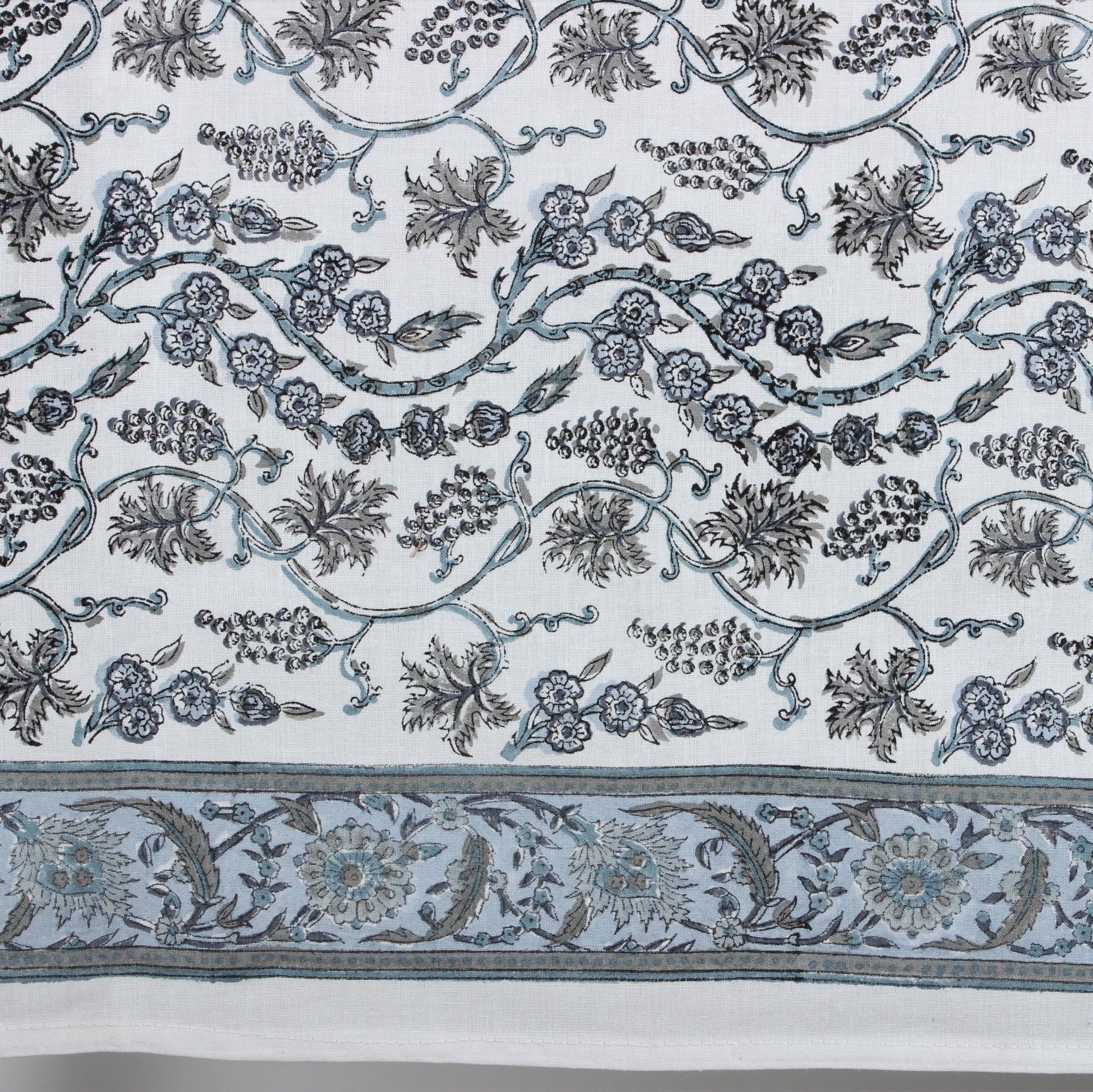 Decorative fabric with intricate floral and leaf patterns on a white background