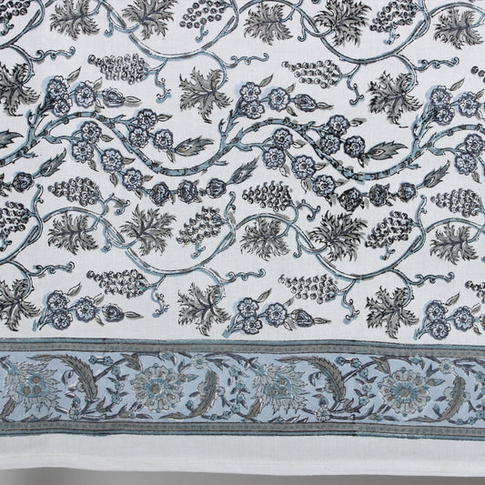 Decorative fabric with intricate floral and leaf patterns on a white background