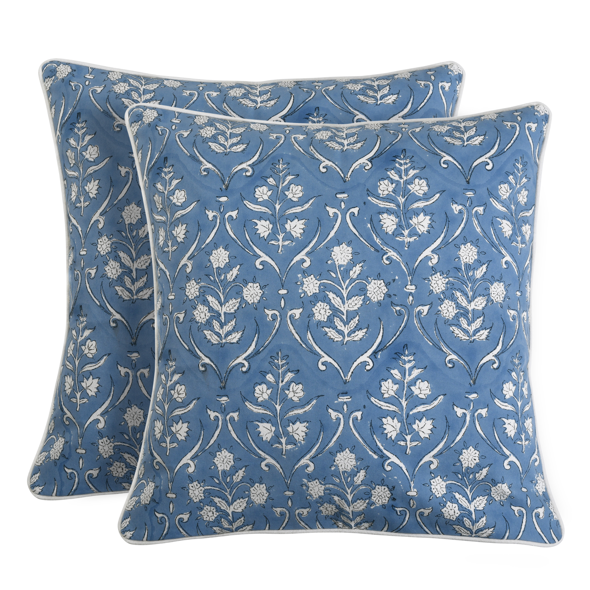 Two blue patterned pillows with white floral design on a white background