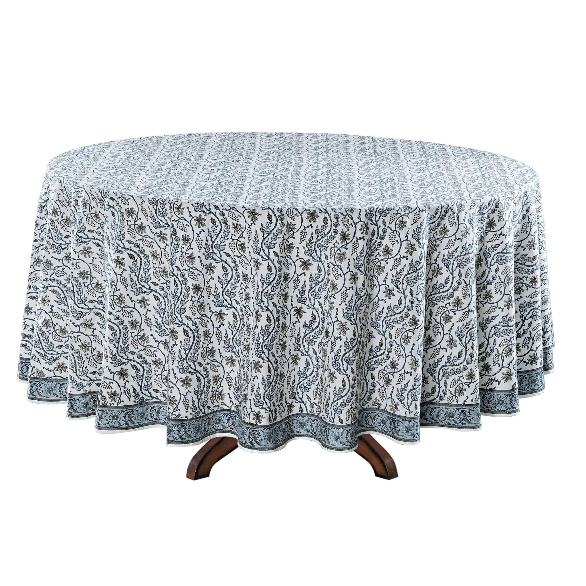 Round table with a patterned tablecloth on a white background