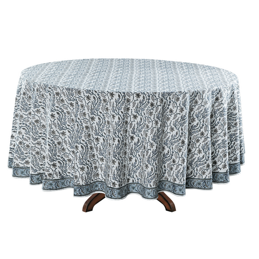 Round table with a patterned tablecloth on a white background