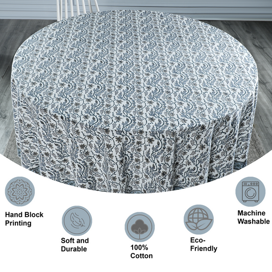Round table with a patterned tablecloth on a wooden floor, with features highlighted below.
