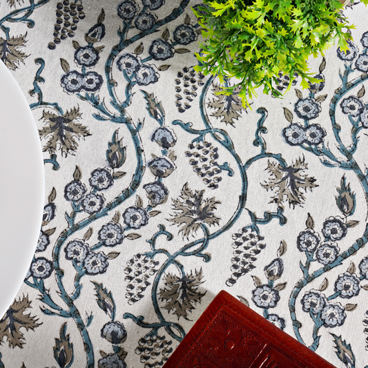 Close-up of a floral patterned fabric with a plant and red object on top
