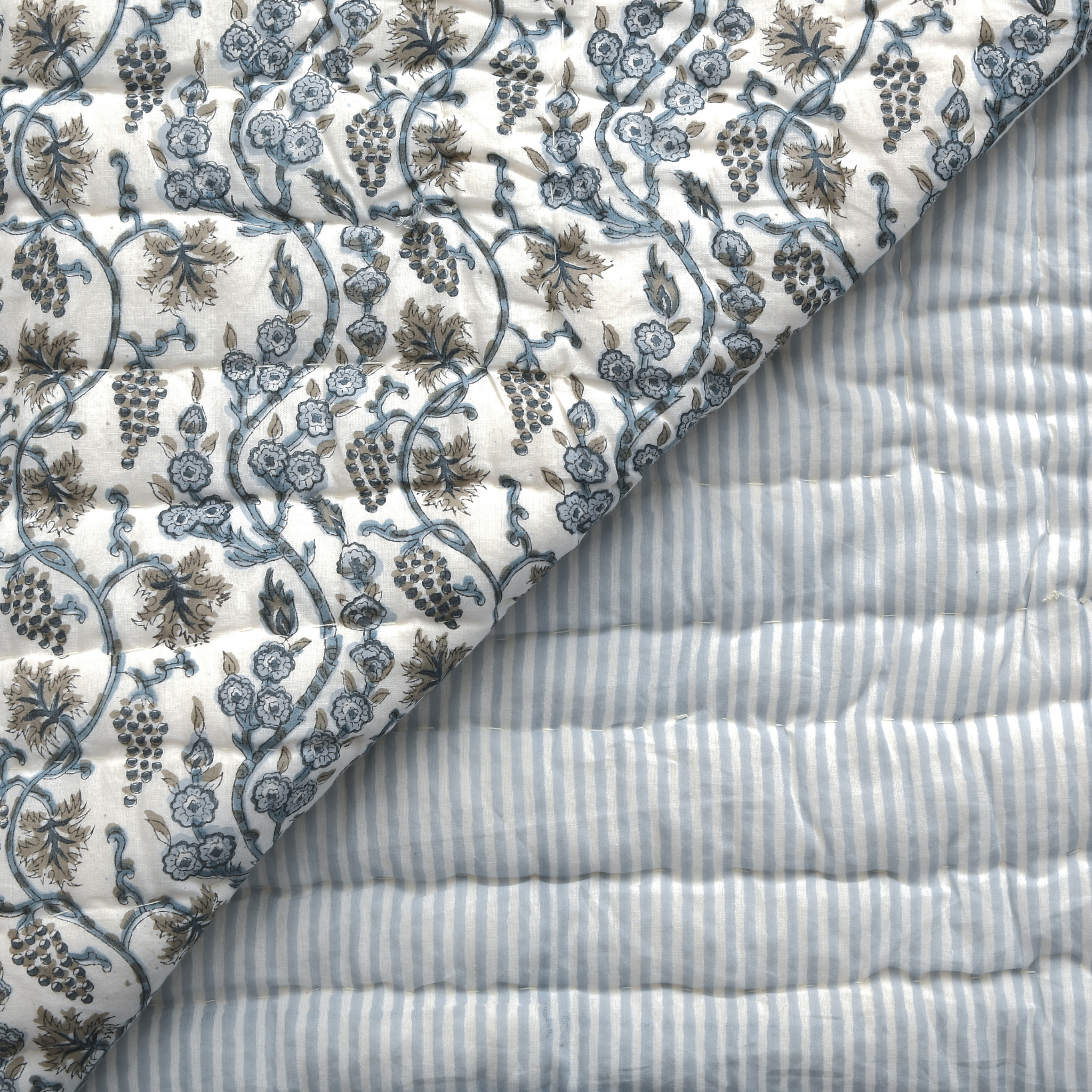Close-up of floral-patterned fabric and striped fabric with visible texture