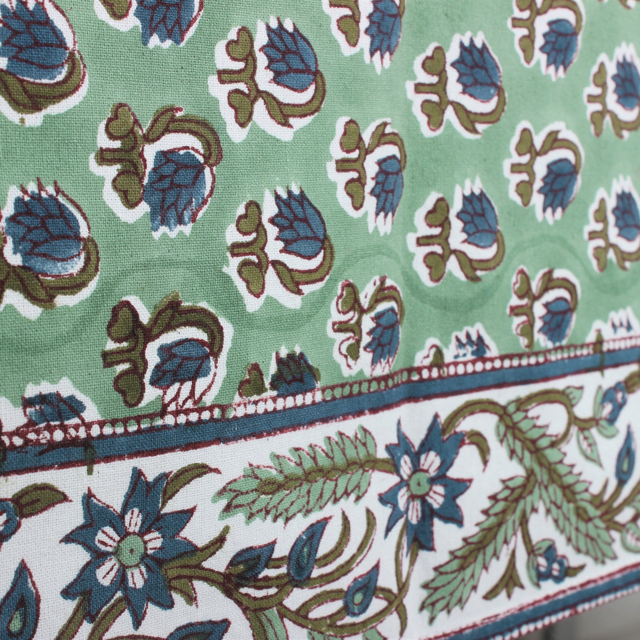 Close-up of a fabric with floral pattern on a green background