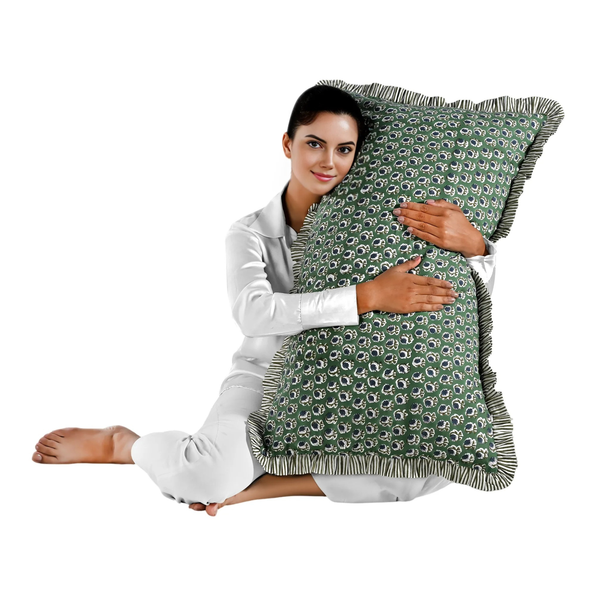 Woman holding a large green floral block print cotton pillow with green edges.