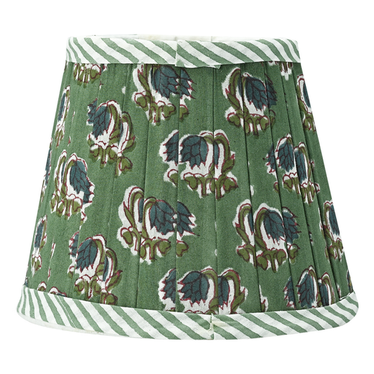 Green pleated skirt with dinosaur pattern and white striped trim on a white background