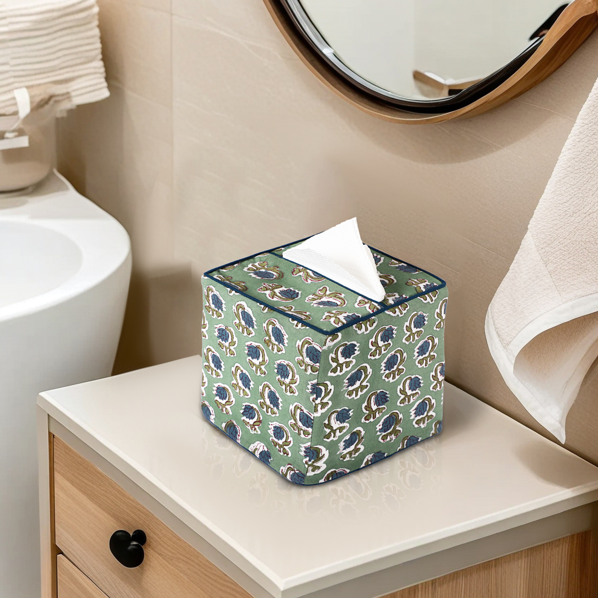 Patterned tissue box on a bathroom counter with sink and mirror in the background