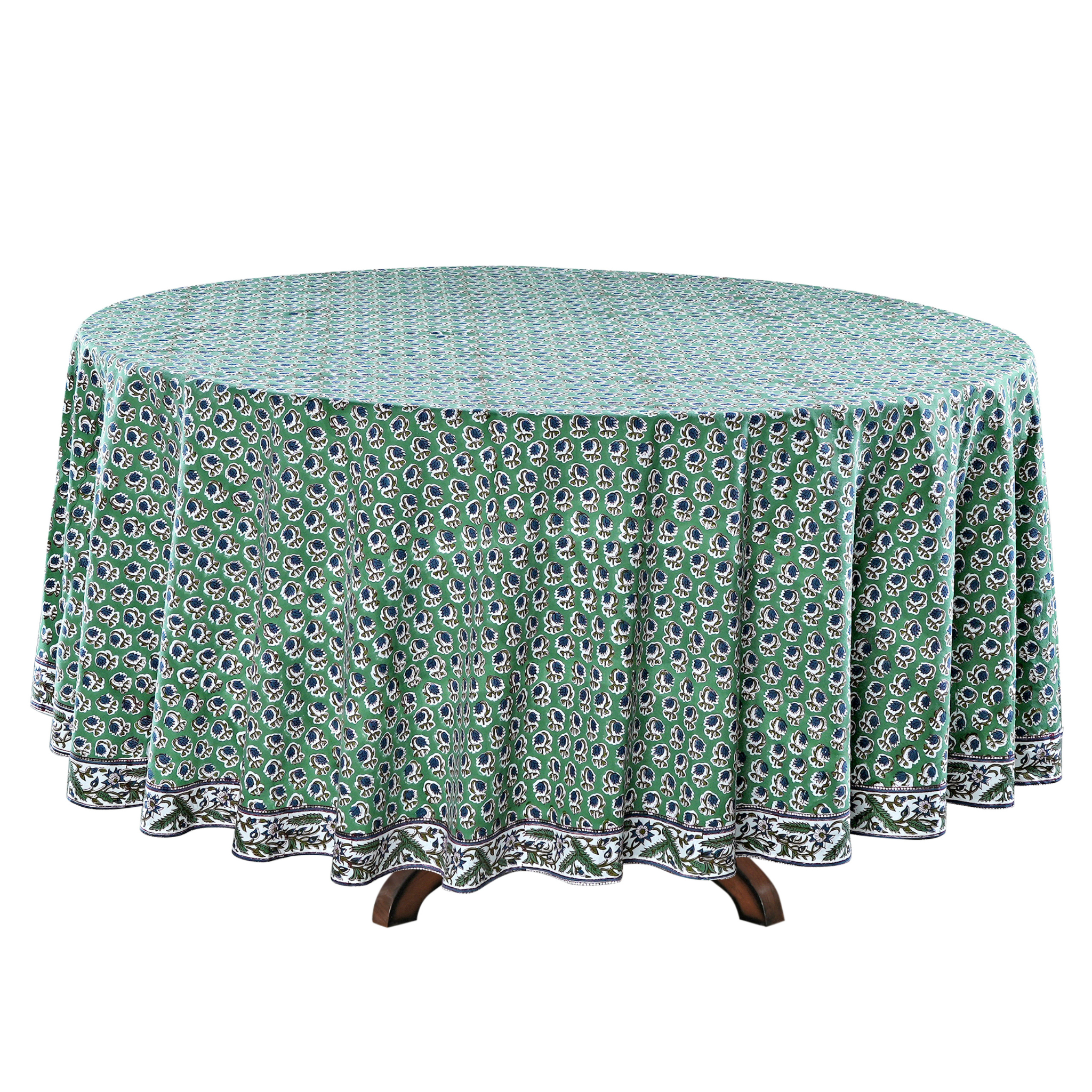 Round table with a green patterned tablecloth on a white background