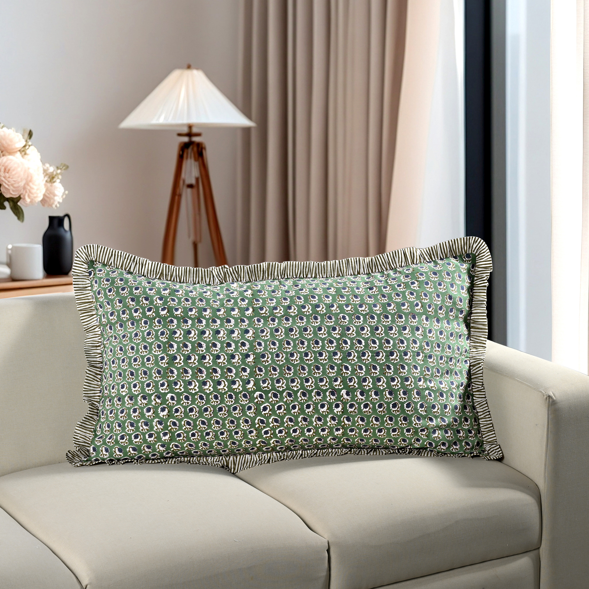 green floral block print cotton pillow styled on a beige sofa in living room.
