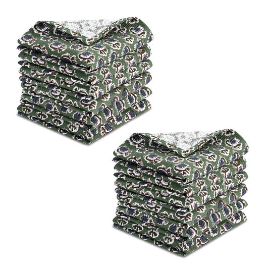Stack of green patterned dish cloths on a white background