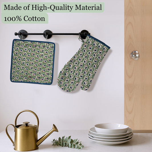 Green patterned pot holder and oven mitt hanging on a rack with kitchen items below.