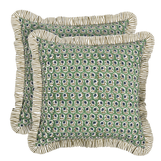 Green patterned pillow with ruffled edge on a white background