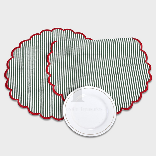 Two green and red striped placemats with scalloped edges on a white background.