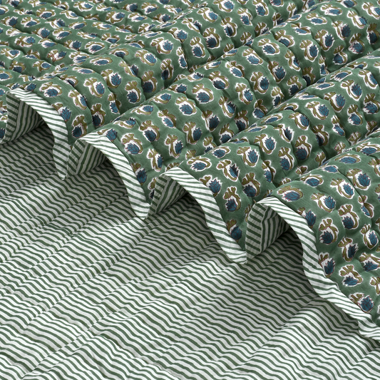Green patterned fabric with white stripes on a textured surface