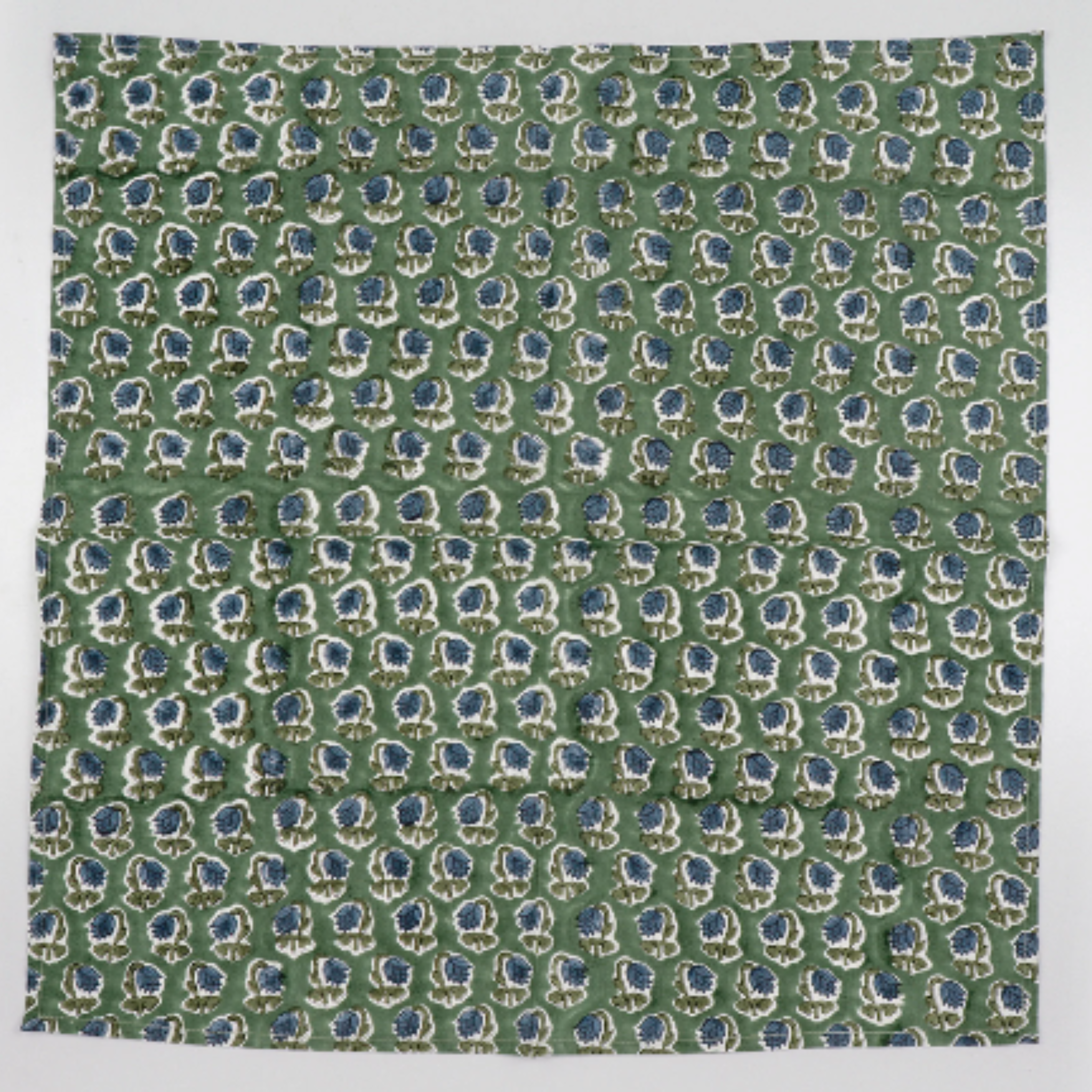 Green fabric with blue and white floral pattern