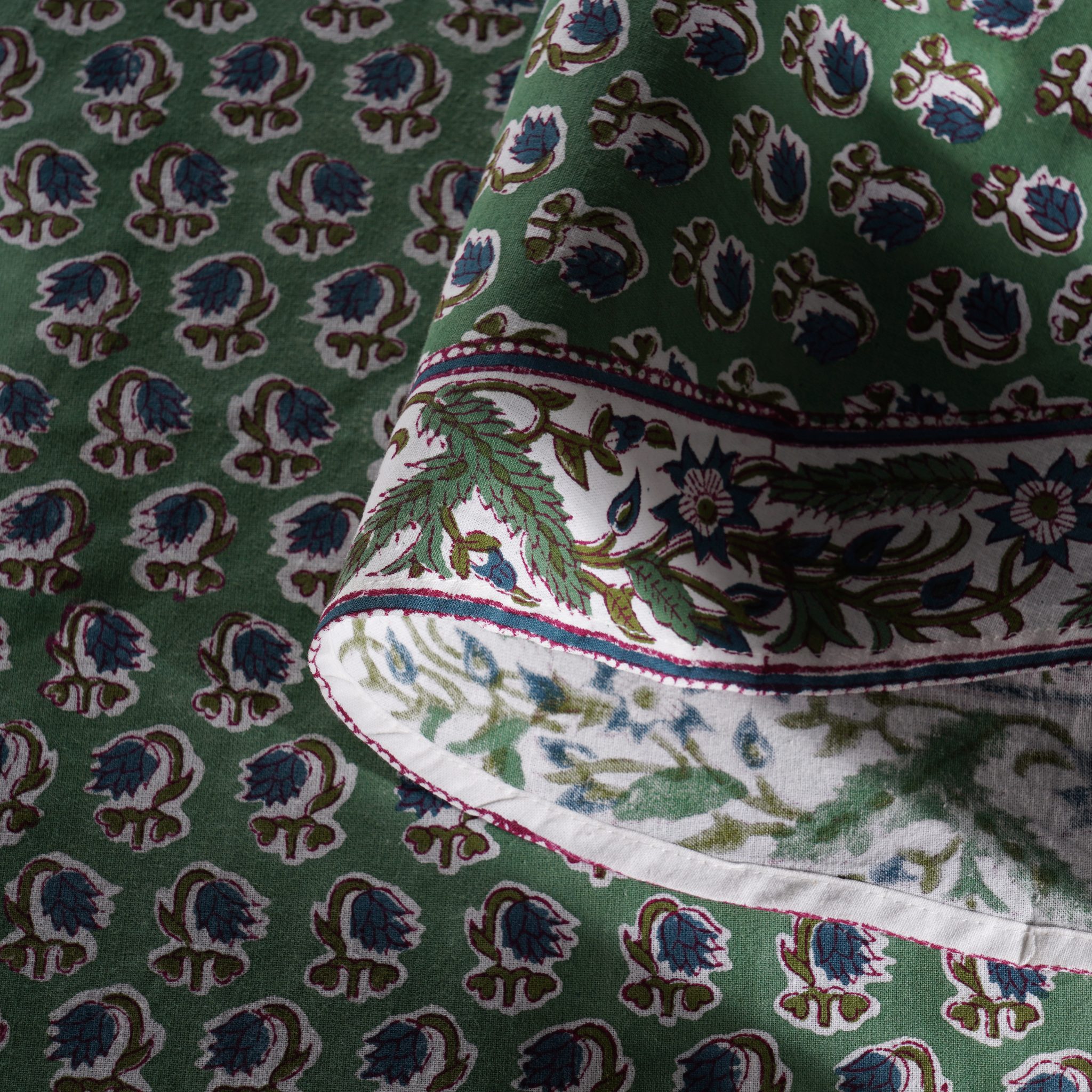 Close-up of green fabric with intricate pattern
