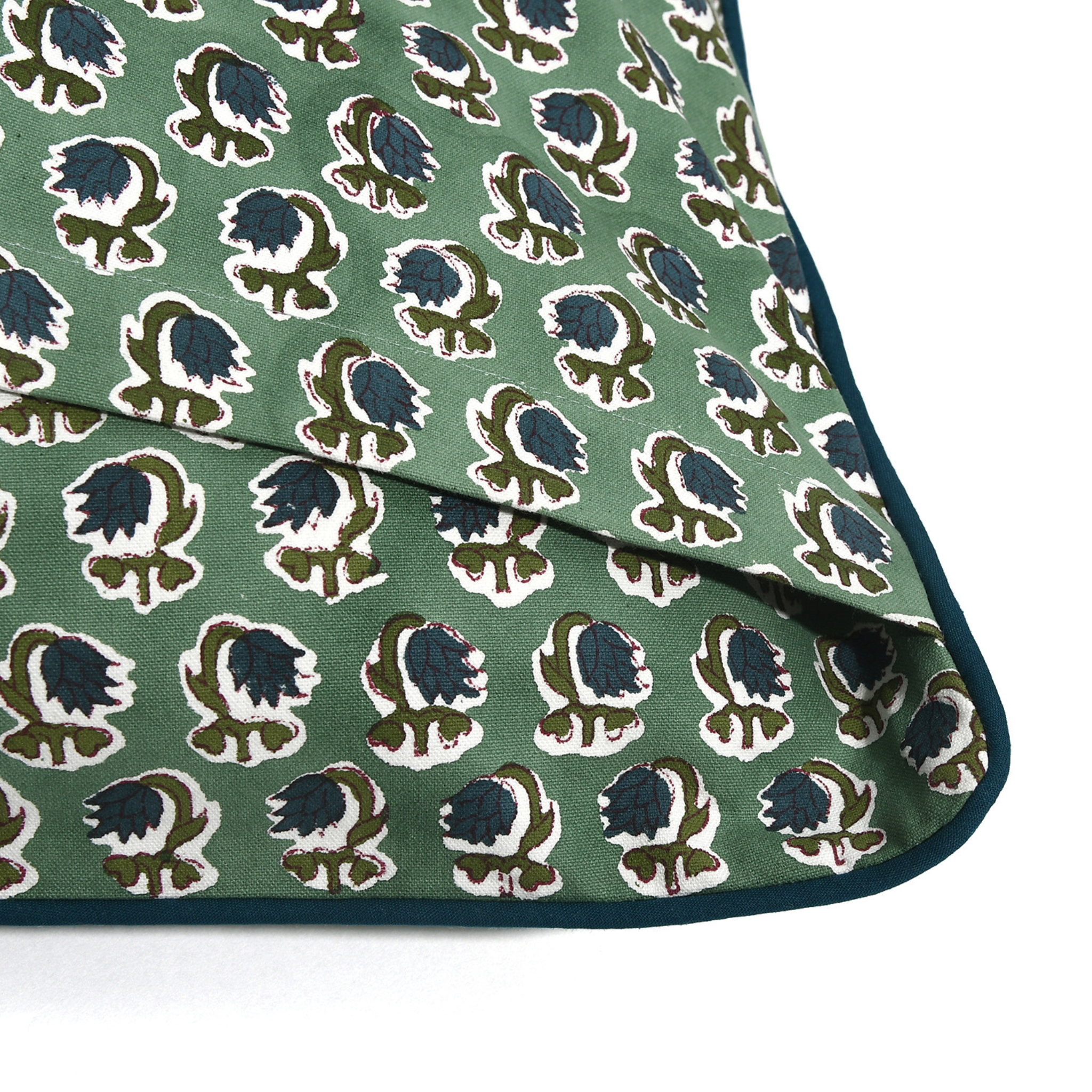 Green fabric with a floral pattern on a white background