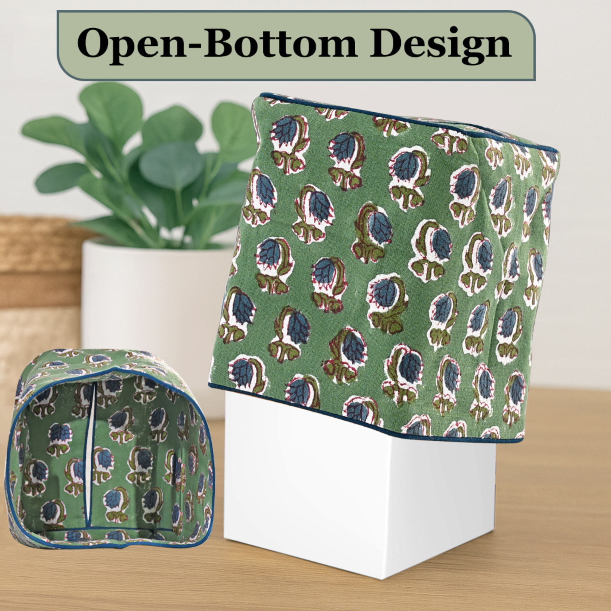 Green patterned open-bottom design on a wooden surface with a plant in the background