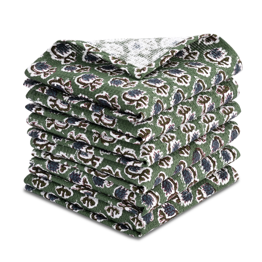 Stack of green patterned dish cloths on a white background