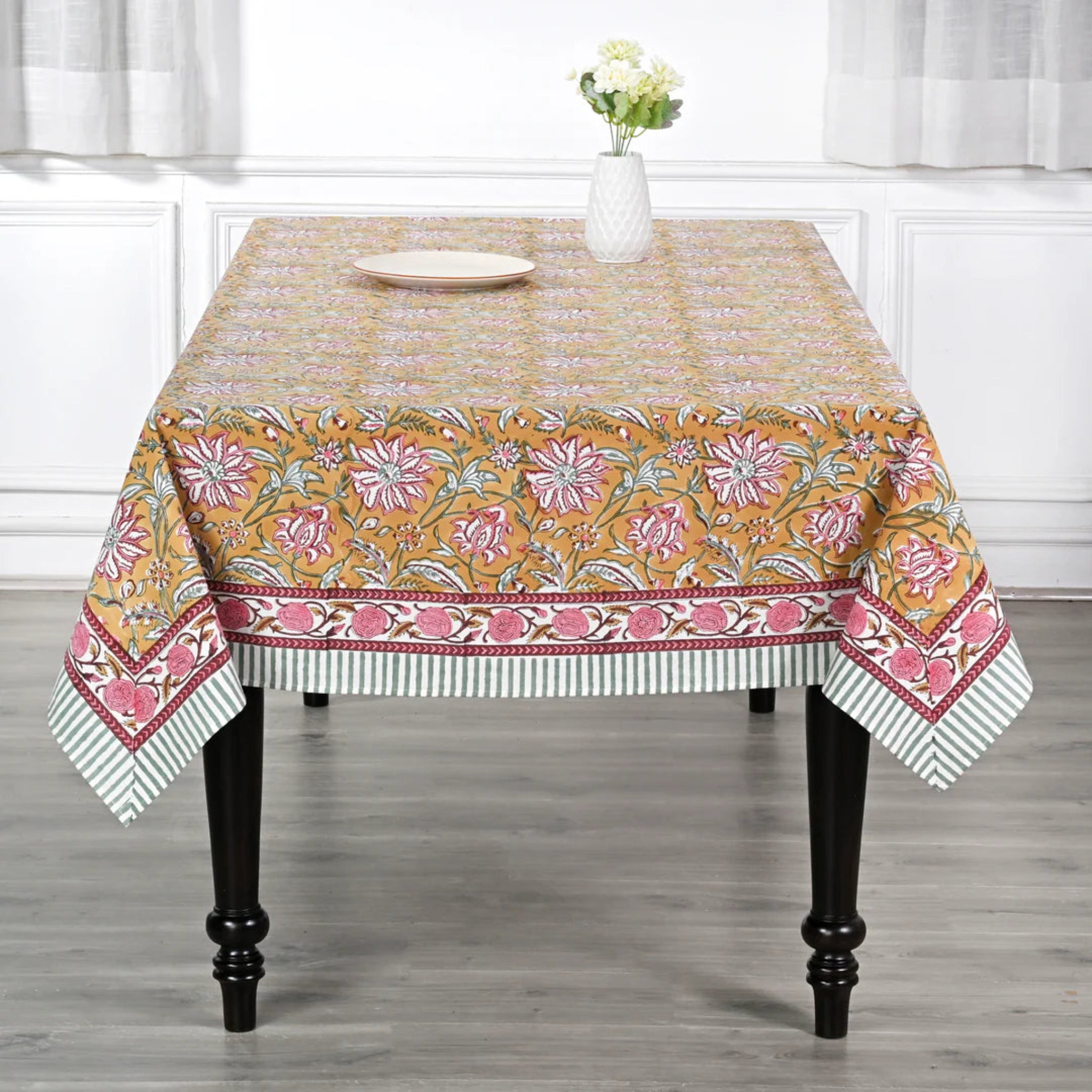 Decorative tablecloth with floral pattern on a wooden table