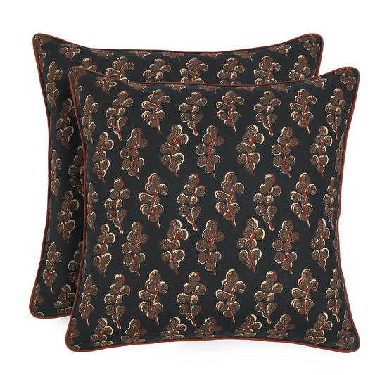 Two decorative pillows with a floral pattern on a black background