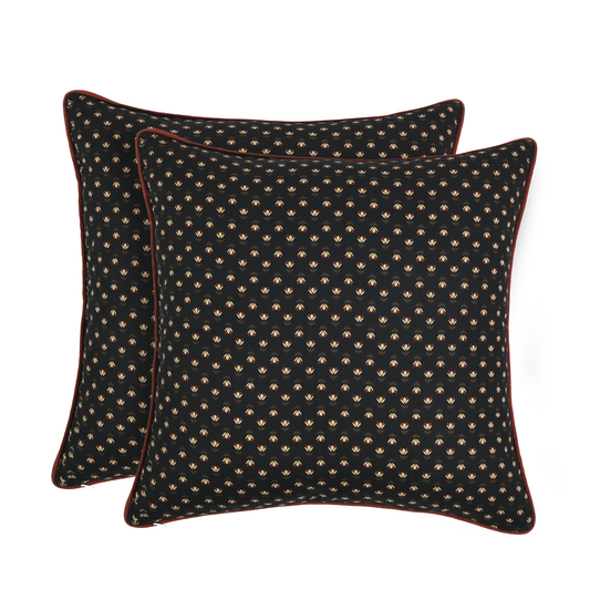 Two black patterned pillows on a white background