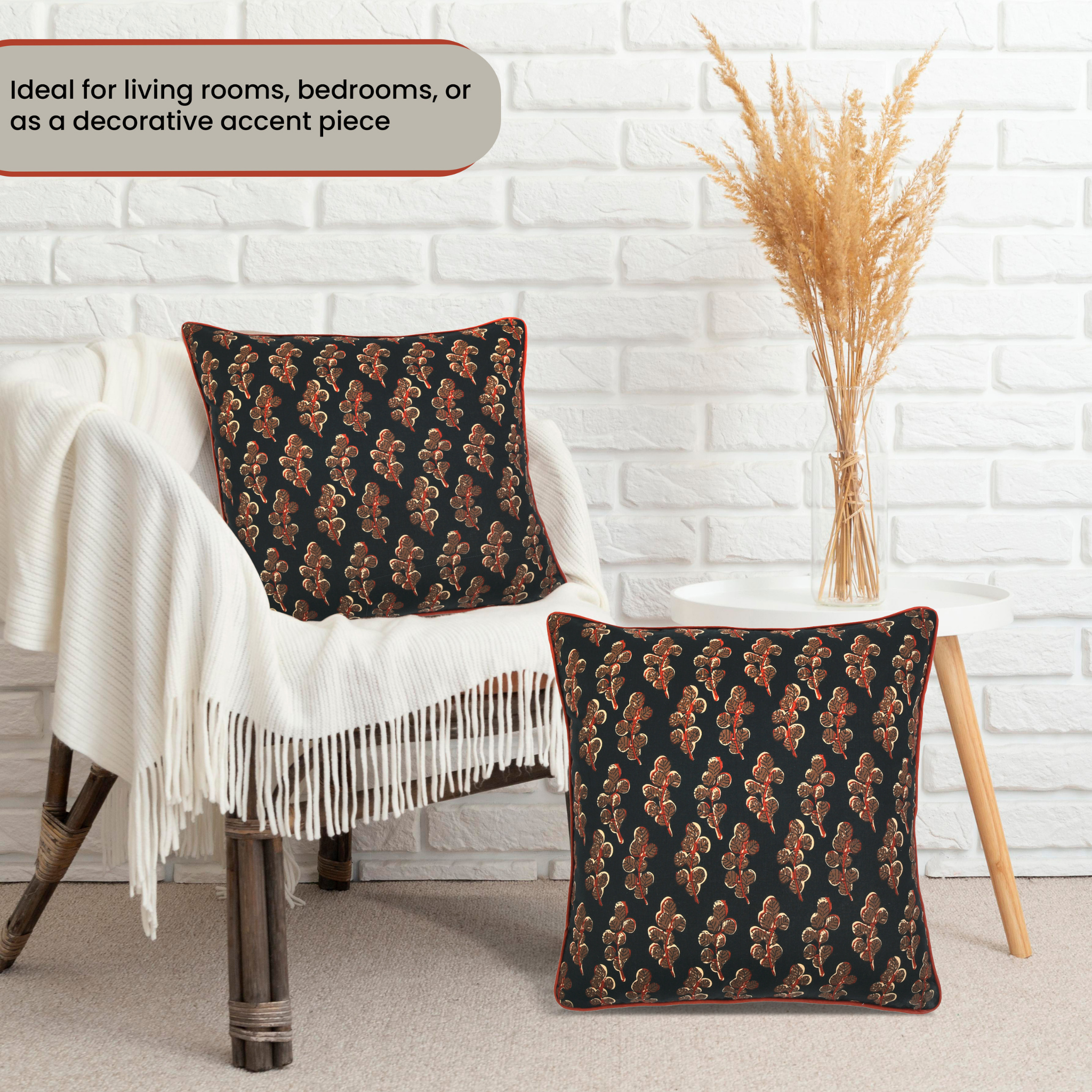 Decorative pillows with a pattern on a chair against a white brick wall.