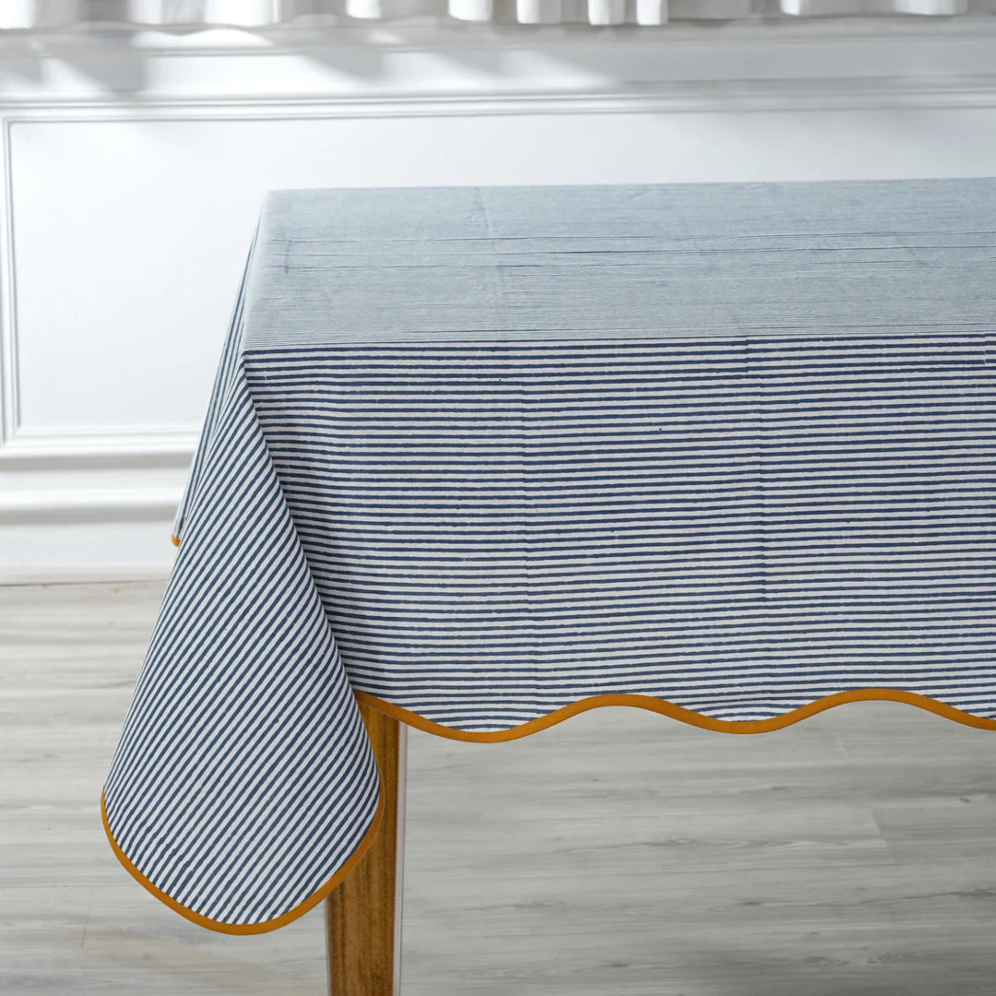 Tablecloth with blue and white striped pattern on a wooden table.